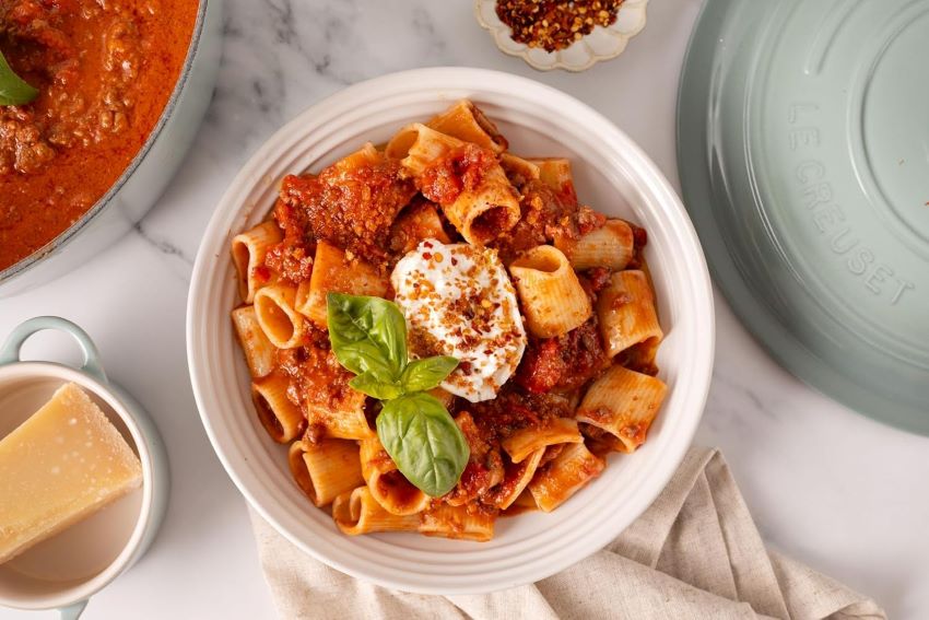 Close-up of Le Creuset stoneware plates and bowls showing design and glaze