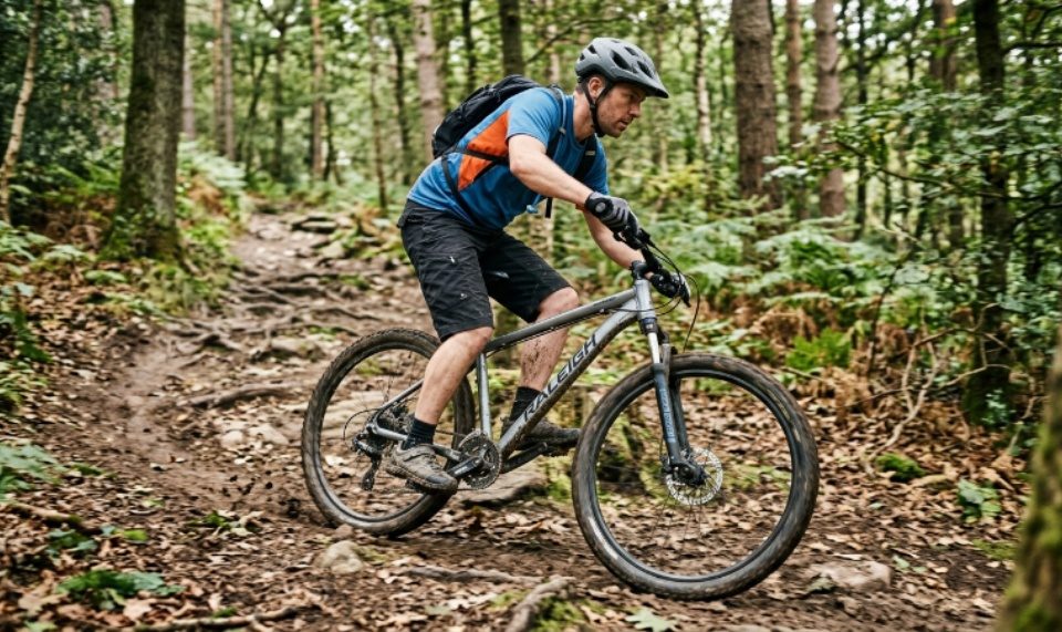 A budget mountain bike on a forest trail showing entry-level cycling gear in action